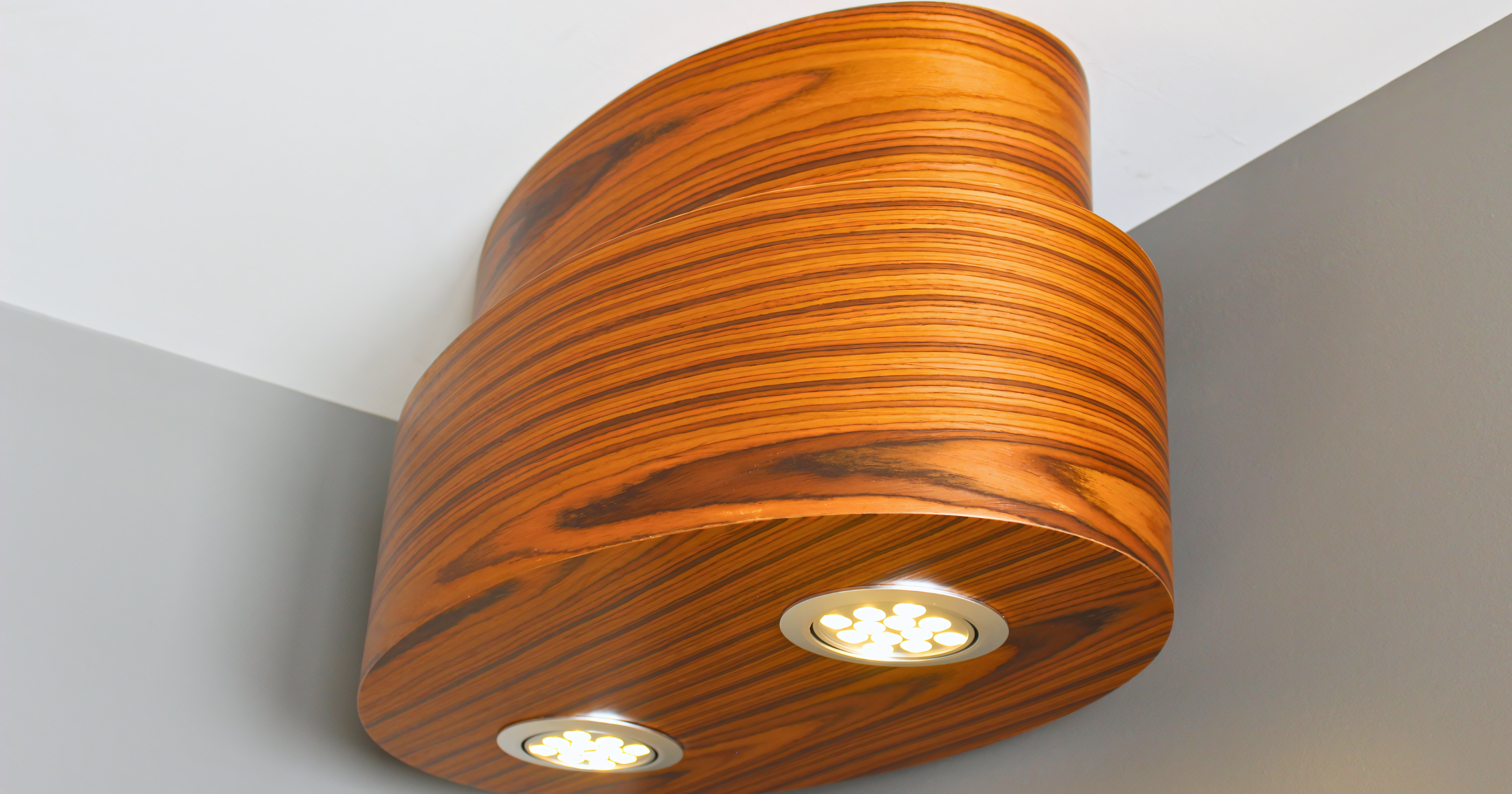 Custom Zebrawood light fixture with an organic tiered shape and integrated LED accent lighting.