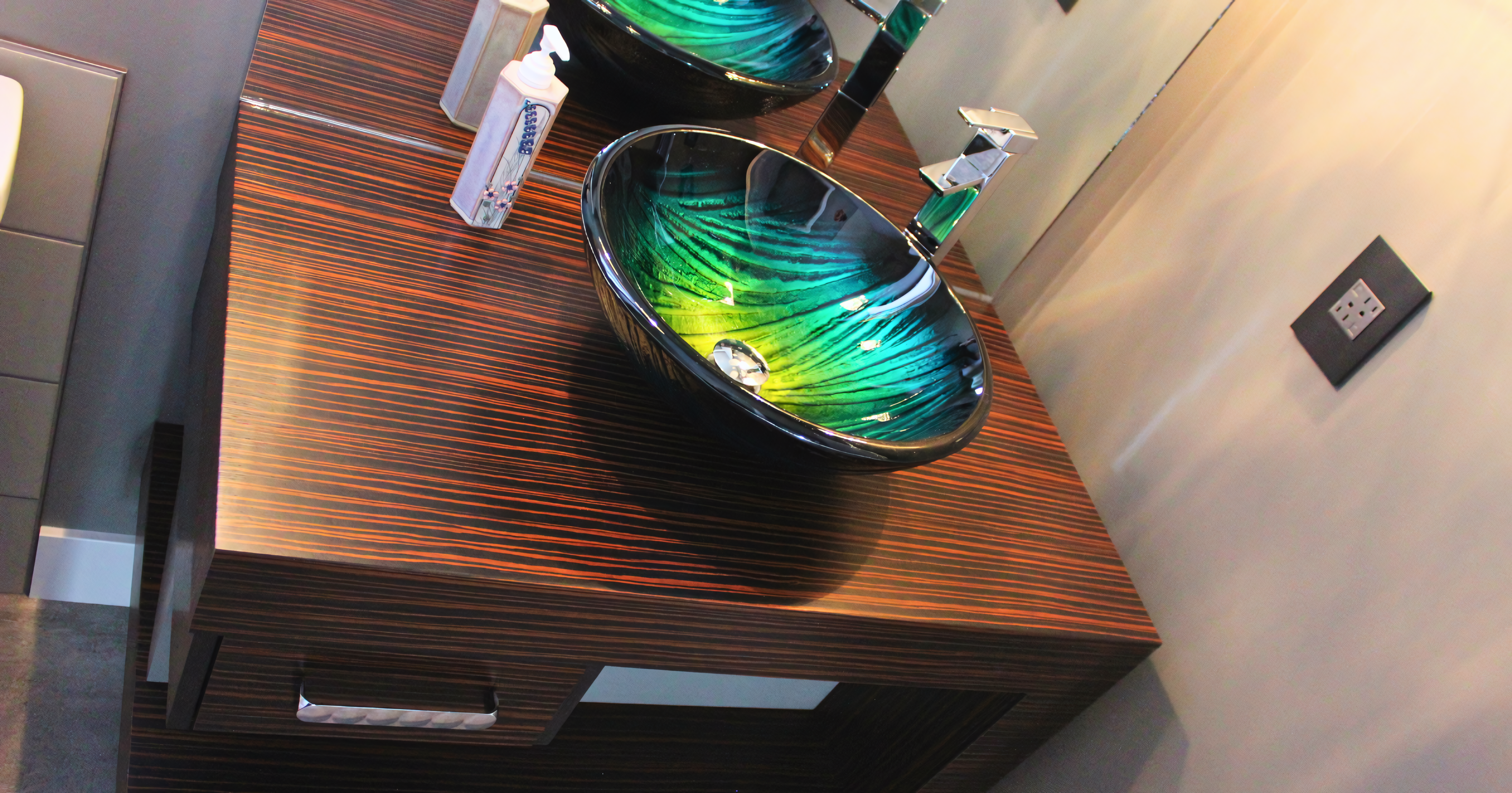 Custom exotic wood floating vanity with vessel sink and horizontal grain matching.