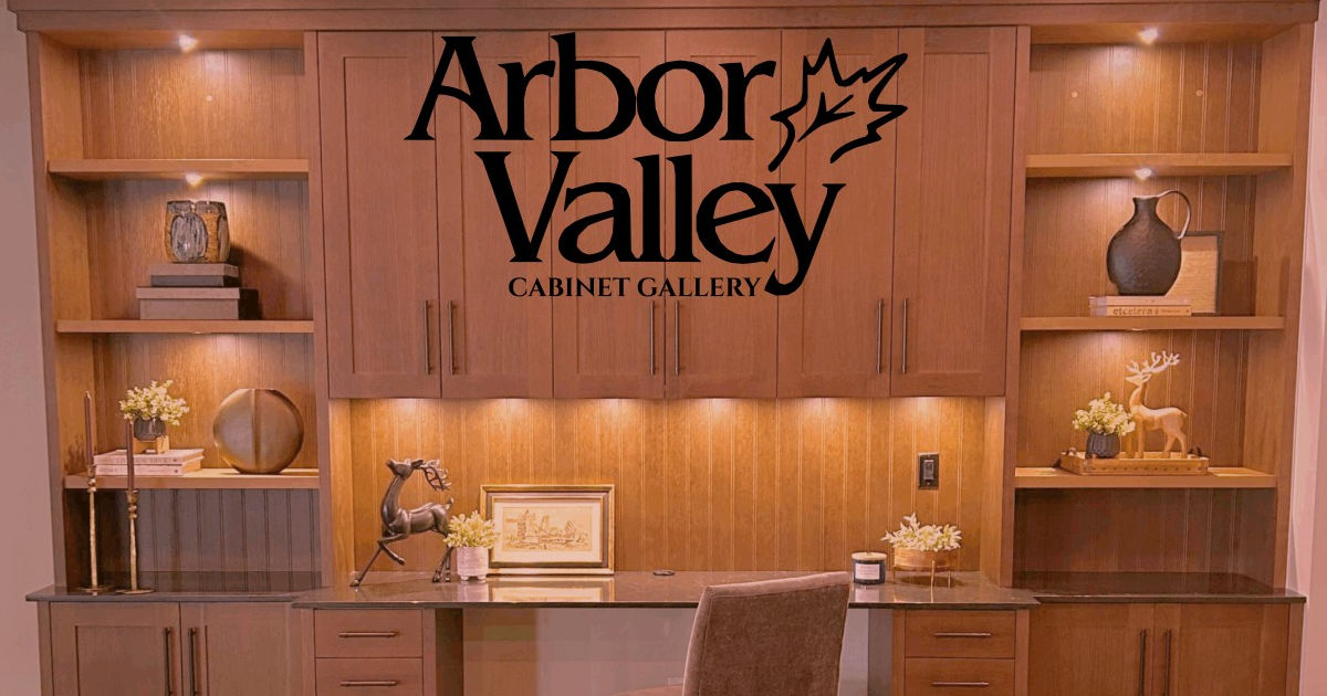 Warm wood panelled bar back wall with open display shelving, integrated downlighting, a large mirror, and a sleek grey quartz prep counter with an undermount sink.