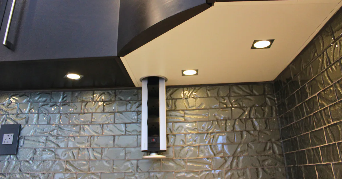 Angled close-up of a modern kitchen corner featuring elegant under-cabinet task lighting