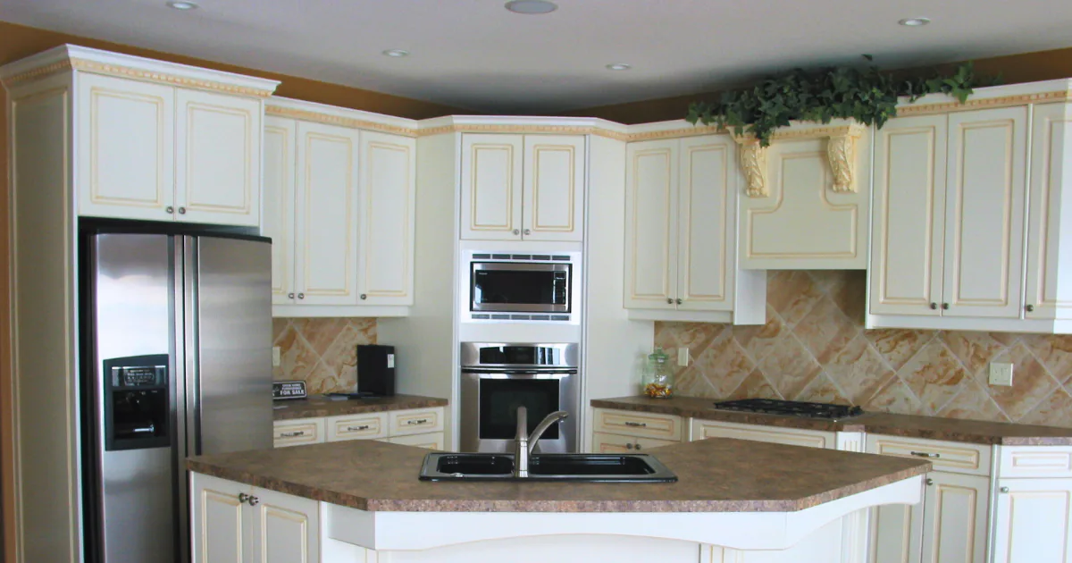 Bright transitional kitchen featuring custom white shaker-style cabinetry, an integrated microwave shelf, and warm under-cabinet task lighting.
